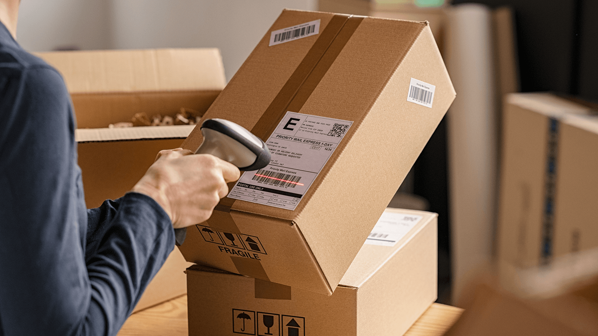 person scanning boxes